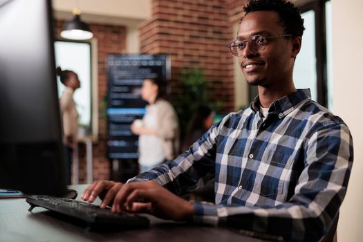 Smiling confident african american software engineer developing machine learning algorithm