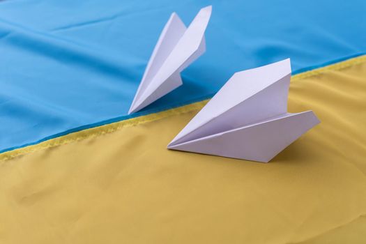 Two paper airplanes with the flag of Ukraine. Handmade arts concept