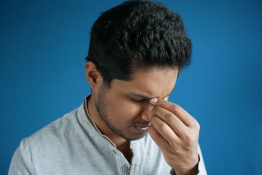 upset man suffering from strong eye pain