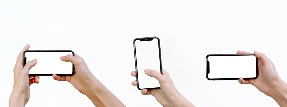 Young man holding a smartphone with a mockup on a white background. Web banner. Smartphone mock-up. Set of hands holding a modern smartphone in different positions with blank screen