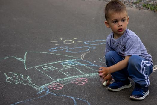 children drawing on asphalt family house