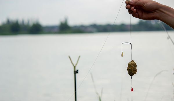 fishing tackle on a wooden float with mountain background and selective focus