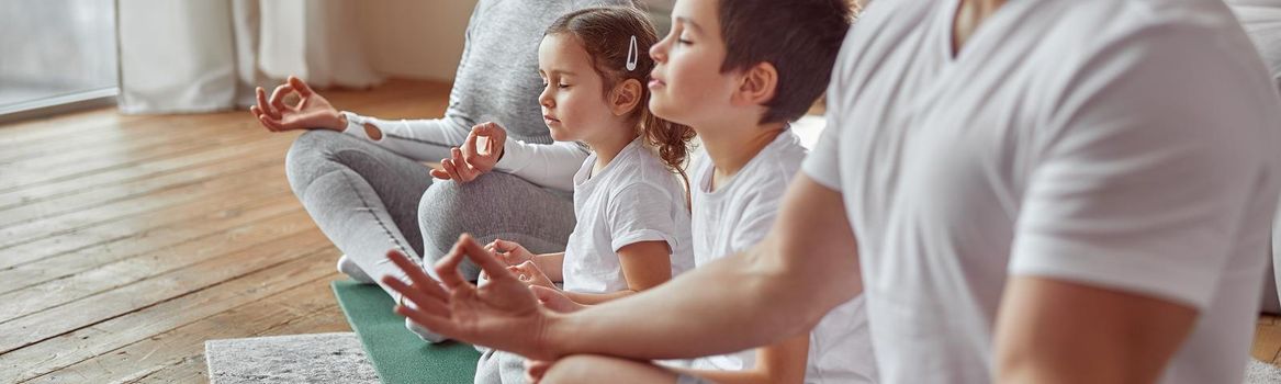 Parents doing meditation with kids at home