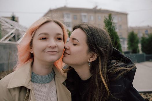 Happy young lesbian couple look on each other with love in their eyes