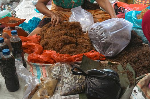 Market vendor selling dried tobacco fibers in Bukit Lawang North Sumatra
