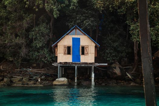 Wooden bungalow built on the water's edge