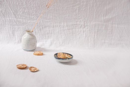 Dried lemon slices on a white delicate background