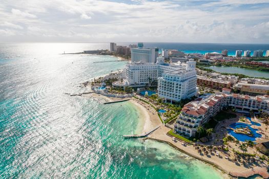 Aerial panoramic view of Cancun beach and city hotel zone in Mexico. Caribbean coast landscape of Mexican resort with beach Playa Caracol and Kukulcan road. Riviera Maya in Quintana roo region on Yucatan Peninsula