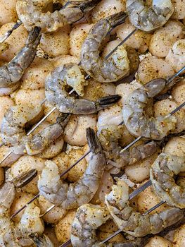 raw seasoned shrimp and scallops ready to grill