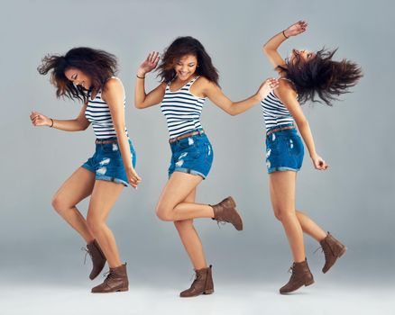 Shes a free-spirit. Composite image of a carefree young woman posing in studio.