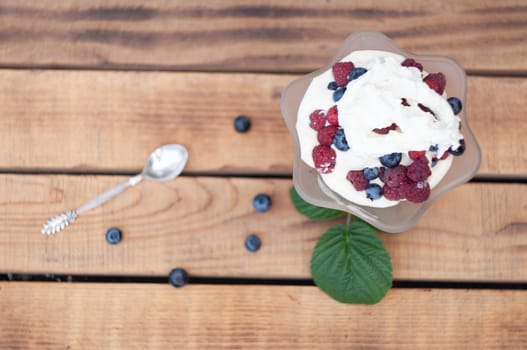 Vanilla ice cream with fresh berries and whipped cream, summer dessert