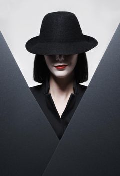 Theres no secret you could hide from me. Studio shot of a mysterious woman wearing a hat against a gray background.