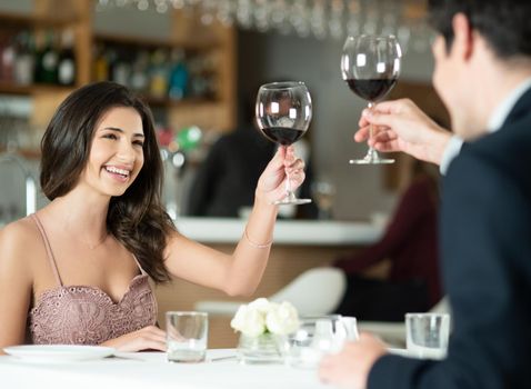Love deserves to be celebrated everyday. Shot of a happy young couple toasting with wine on a romantic date at a restaurant.