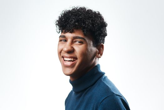 An awesome smile with style match. Studio shot of a confident young man posing against a grey background.