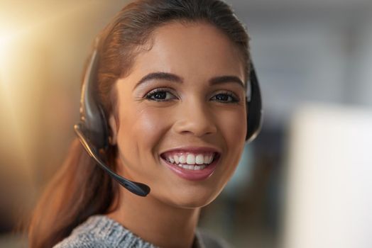 The friendly face that is here to help you. Shot of a young female agent working in a call center.