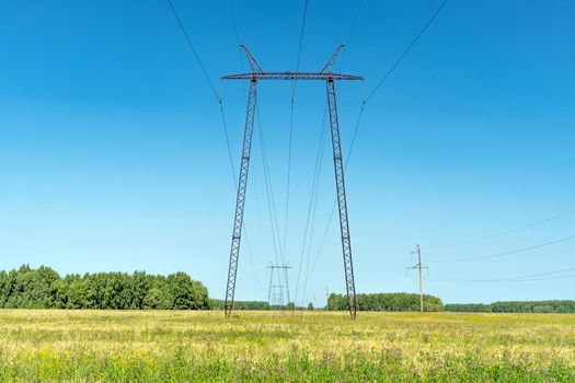 Production of fuel and electricity.Electrical networks with wires and transformers at sunset.Power transmission lines and from the power plant.Power lines with wires under voltage and electric current