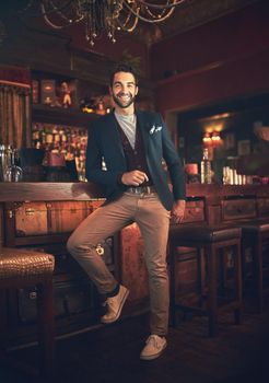 Its my favourite bar. Full length portrait of a young man standing in a bar.