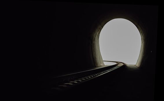 Inside the railroad tunnel and railways with natural light at the end. Light at the end of the tunnel, Lights and shadows, Concept of achieving your goals, Copy space, No focus, specifically.
