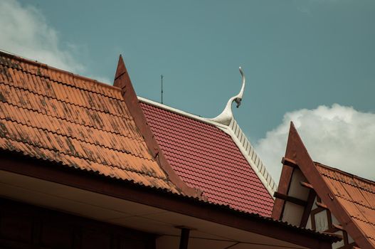Thai temple art and architecture on traditional roof of buddhist temple. Roof style of thai temple with gable apex features on the top, Selective Focus.