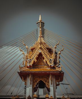 Bangkok, Thailand. Mar - 12, 2022 : Beautiful of Buddhist temple with suspension bridge background. Selective focus.