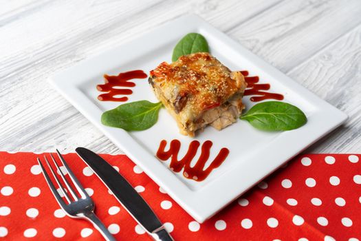 Delicious veal cutlet with melted mozzarella cheese on white plate