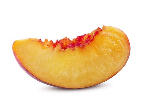 Unpitted, smooth-skinned nectarine fruit slice isolated on white background with copy space for text or images. Close-up shot.