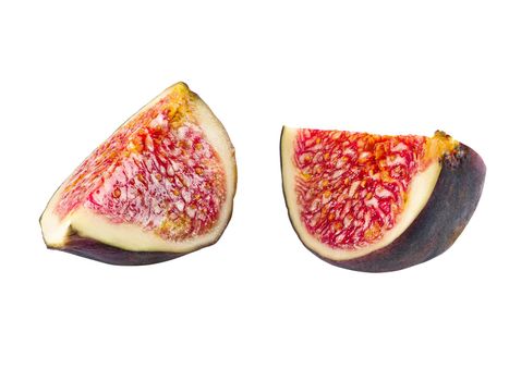 Two slices of purple fig isolated on white background with copy space. Soft, sweet fruit, skin is thin, red flesh has many seeds. Close-up.