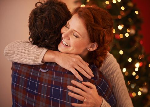 Merry Christmas, babe. Cropped shot of an affectionate young couple embracing at Christmas.