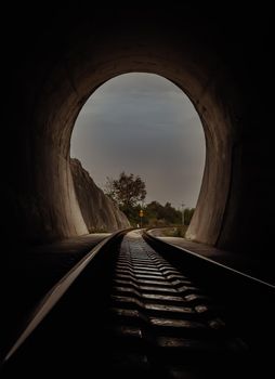 Inside the railroad tunnel and railways with natural light at the end. Light at the end of the tunnel, Lights and shadows, Concept of achieving your goals,