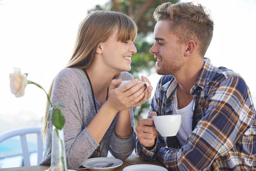The perfect way to start the day is with you. A young couple enjoying breakfast outside.