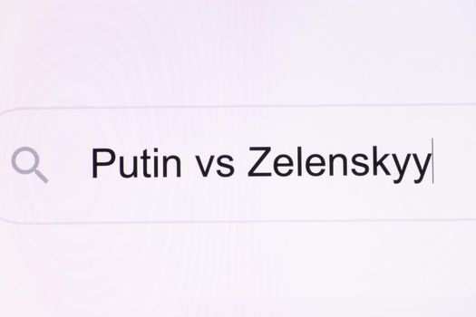 Close Up of searching for Putin vs Zelensky on the Internet. Putin vs Zelensky headline titles across international media in white background. President of Ukraine Volodymyr Zelensky vs Putin Russia.
