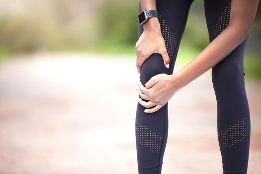 I should stop and see to this first. Closeup shot of an unrecognisable woman experiencing knee pain while exercising outdoors.