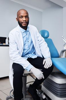 Your comfort is our number one concern. Portrait of a confident young man working in a dentists office.