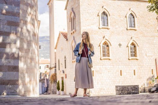 Young woman tourist in the old town of Budva. Travel to Montenegro concept