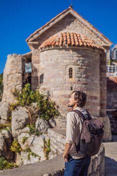 Young man tourist in the old town of Budva. Travel to Montenegro concept
