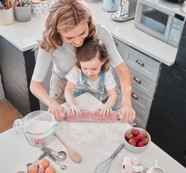 The measuring and mixing always smoothed out her thinking processes. Shot of a mother and daughter baking in the kitchen at home.