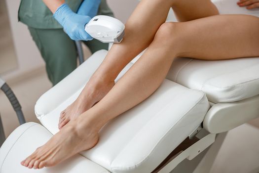 Smooth skin of legs. Photo epilation procedure in beauty salon
