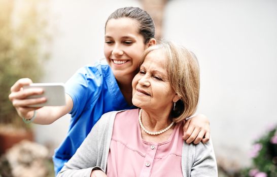I want to capture all of our memories. Cropped shot of a caregiver taking a selfie with a senior patient outside.