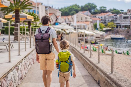 Dad and son tourists walks along the coast of Budva in Montenegro