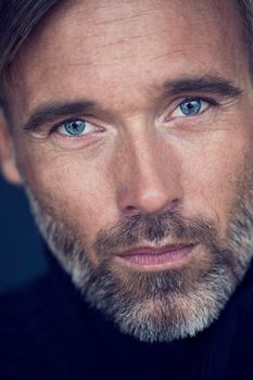 These baby blue eyes will melt your heart. A handsome mature man looking at the camera - close up.