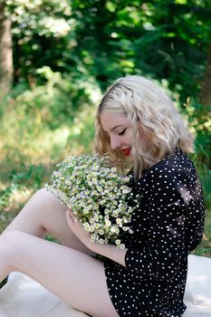 touching portrait of a charming blonde girl with bouquet of white wildflowers. female with flowers