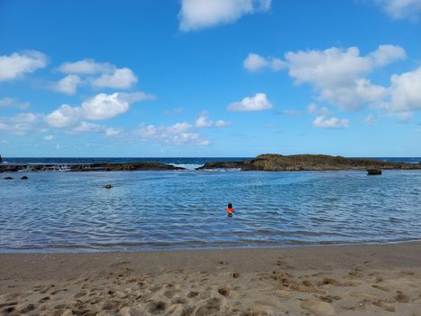 child swimming at beach in Isabela, Puerto Rico