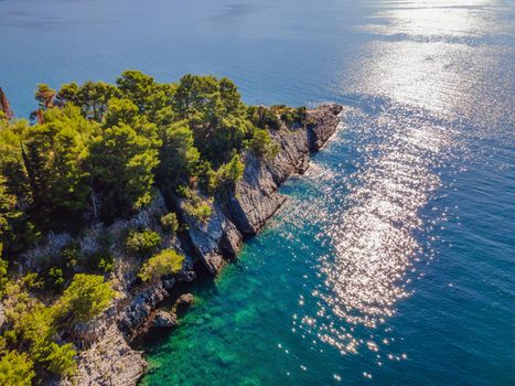 Picturesque sea Adriatic coast of Montenegro. Turquoise Mediteran sea and rocky shore with evergreen coniferous trees. Wonderful summer landscape. Drone