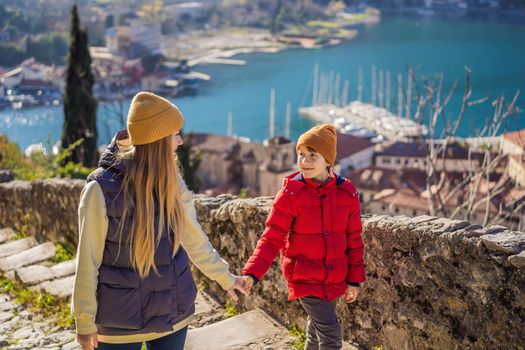 Mom and son travelers in Montenegro in Kotor Old Town Ladder of Kotor Fortress Hiking Trail. Aerial drone view