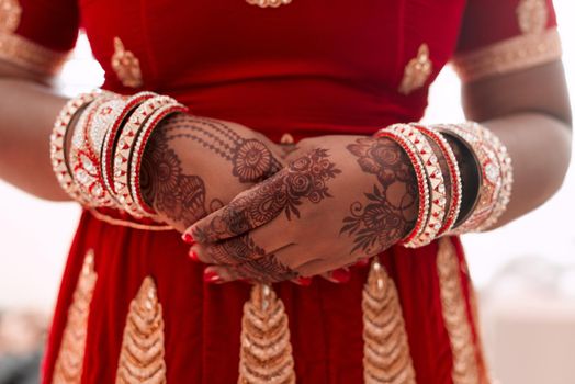 My beauty as a bride is in my henna. Cropped shot of an unrecognizable bride standing with mehendi on her hands on the morning of her wedding.