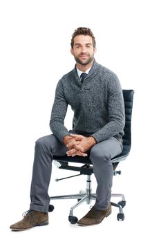 Take a seat, we have some work to do. Studio portrait of a handsome businessman sitting on a chair against a white background.