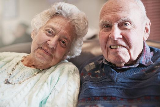 We made a promise to stick together forever. Portrait of a senior couple relaxing together at home.