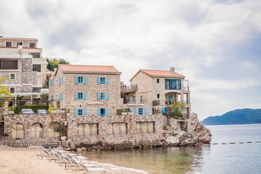 Picturesque summer view of Adriatic sea coast in Budva Riviera near Przno village. Cozy beach and buildings on the rock. Location: Przno village, Montenegro, Balkans, Europe