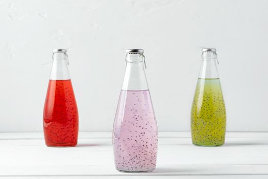 Basil seed drink in glass bottles on white background, close up