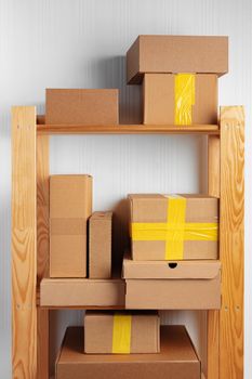 Stack of cardboard package boxes on wooden rack